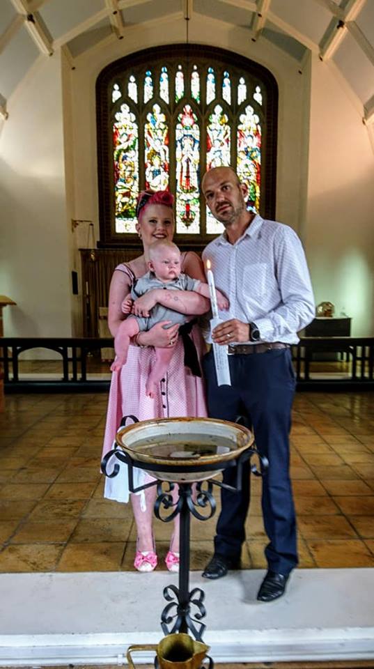 Baptism family at the font inside St Barnabas church